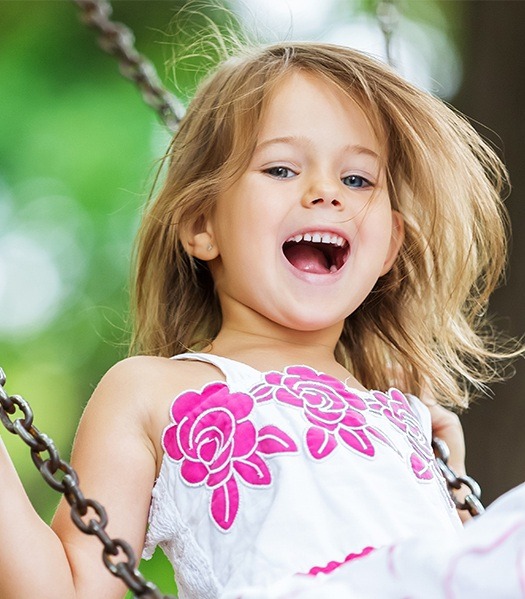 young girl swinging