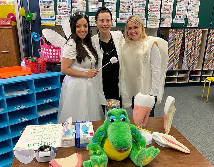 team members dressed as tooth and tooth fairy with Dr. Arrington