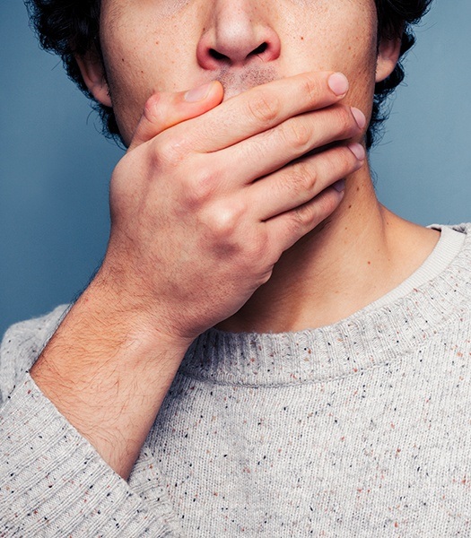 man covering mouth