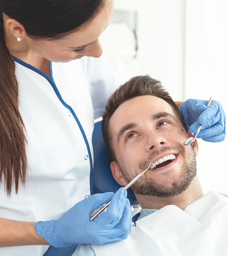Dentist working on man's smile