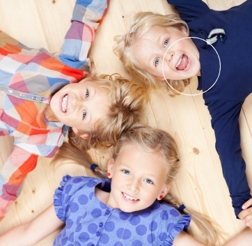 three kids laying on floor