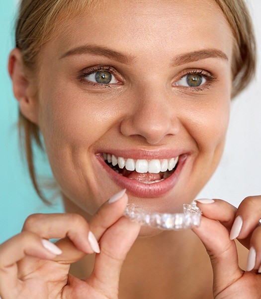 girl holding invisalign