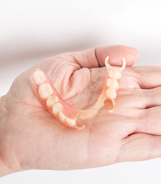 hand holding partial denture