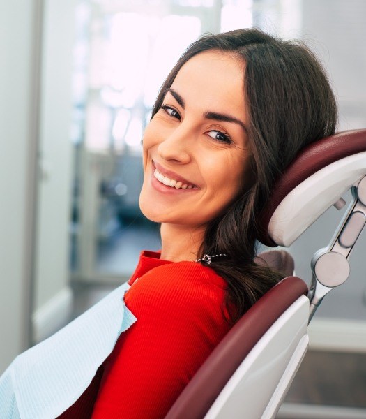 woman smiling over shoulder in exam chair