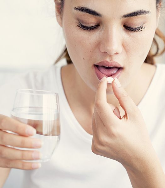 woman taking oral sedation pill