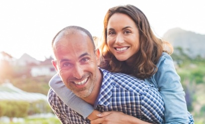 husband giving wife piggyback ride