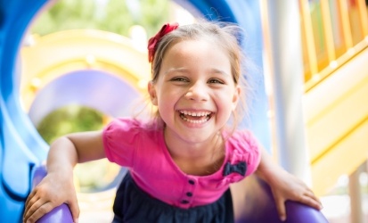 girl smiling on slide