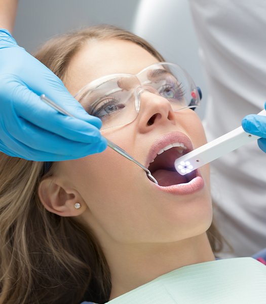 girl with intraoral camera in mouth